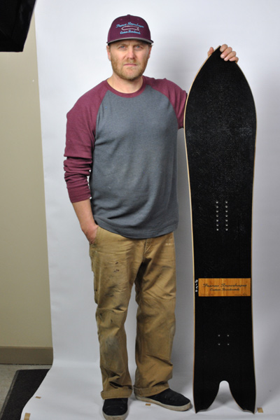 Mikey Franco standing with one of his custom boards. [Photo] Patrick Shehan