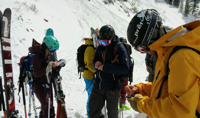 Mitchell on far left takes notes about the skis she has been testing. [Photo] Louise Lintilhac