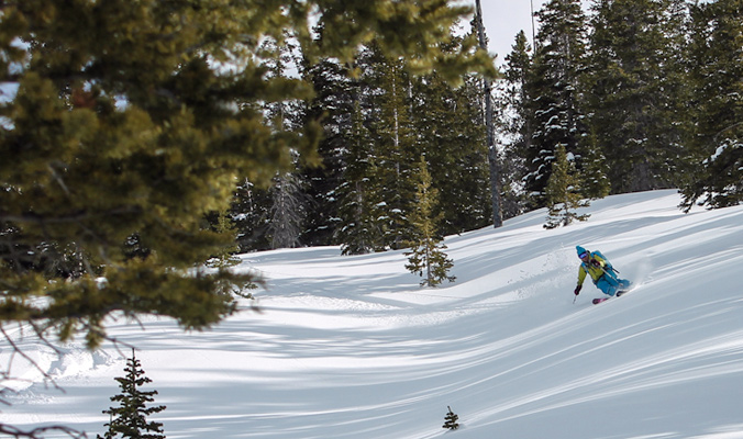 Anna Catino carving powdery goodness in the forest. [Photo] Erme Catino